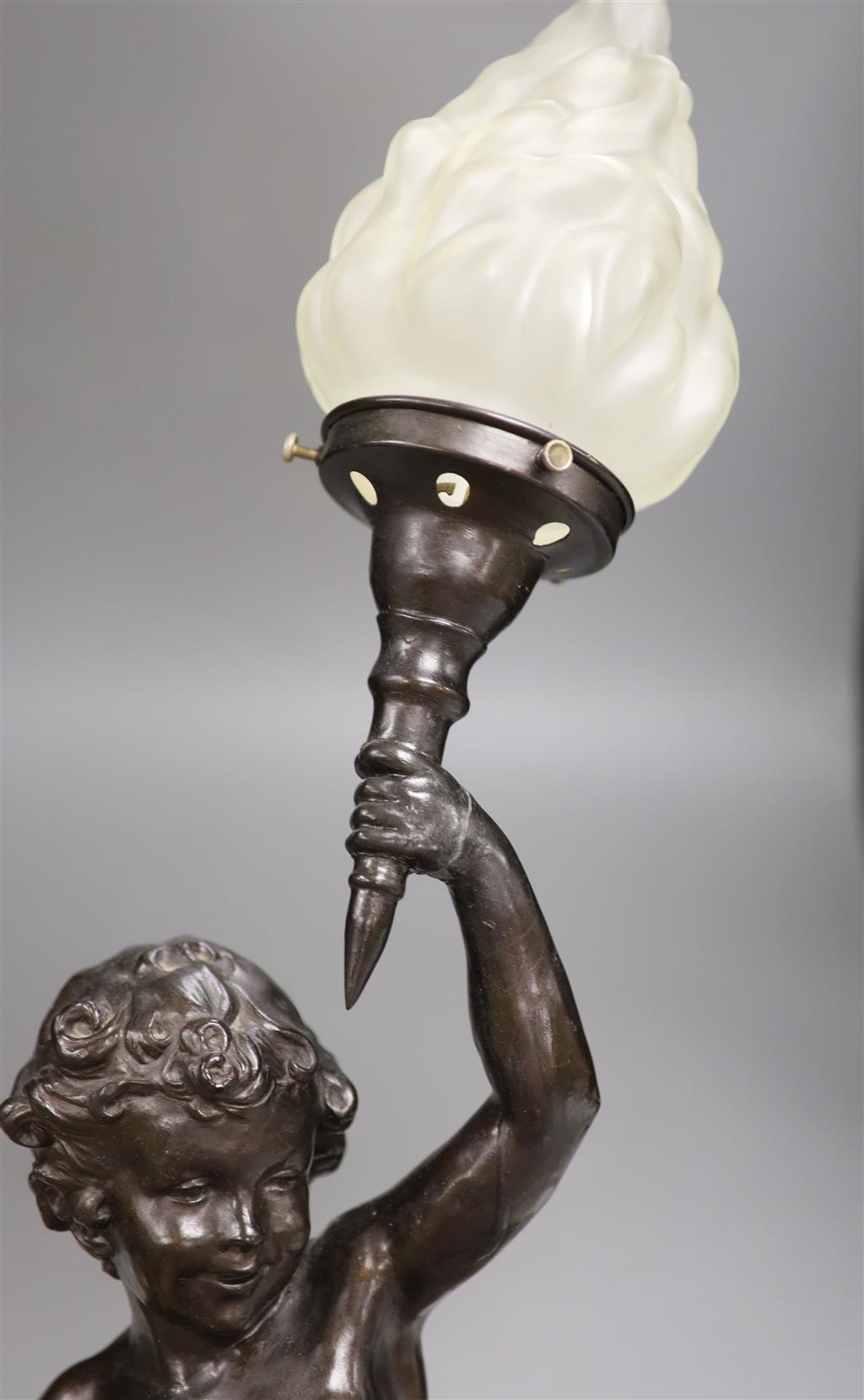 A spelter cherub lamp with flame shade, height 89cm